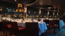 Romantic dinner with illuminated Eiffel Tower view from a dinner cruise